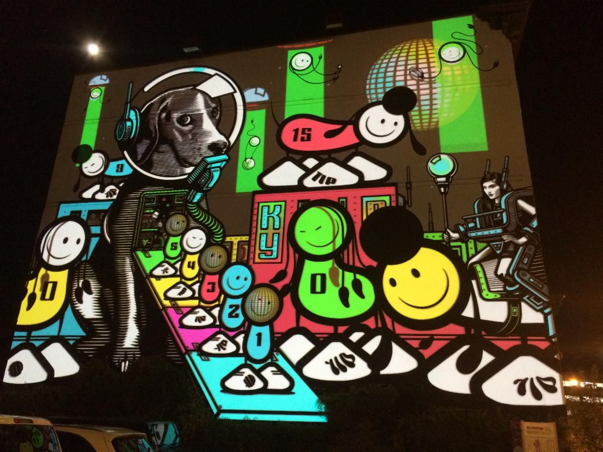 A building with a mural lit up with projection mapping during BLINK 2019. (Photo courtesy of City of Covington)