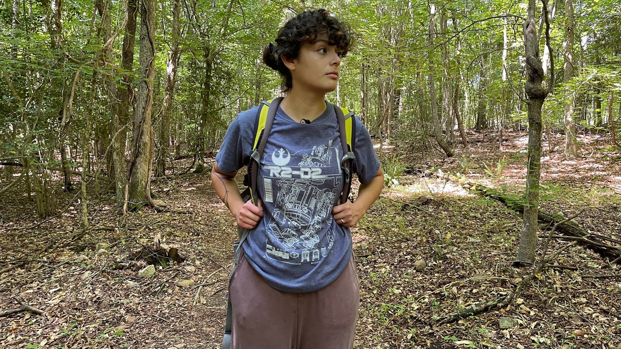 Latina hiking with backpack on