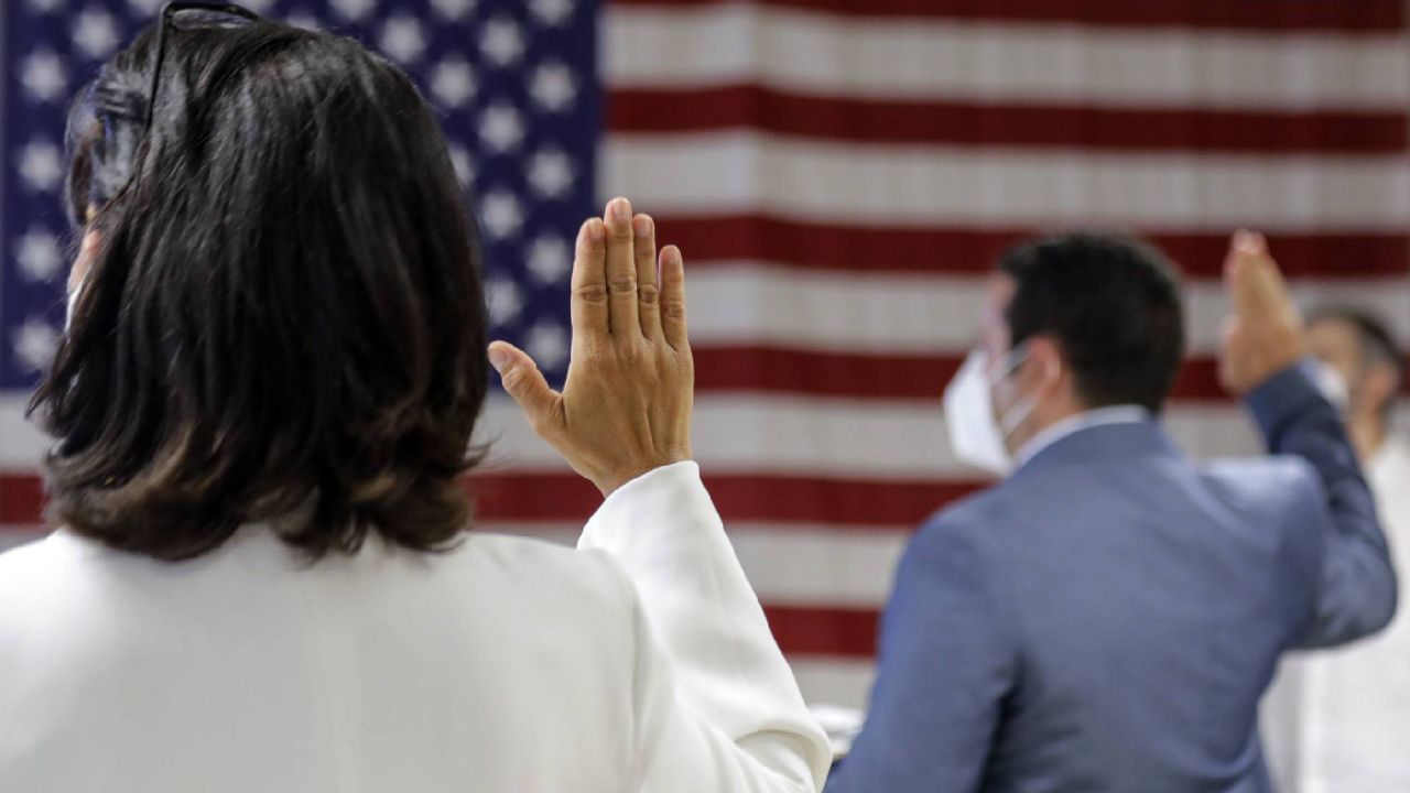 FILE - In this July 2, 2020, file photo, people take the oath of citizenship during a naturalization ceremony at U.S. Citizenship and Immigration Services Field Office in New York.  (AP Photo/Frank Franklin II, File)