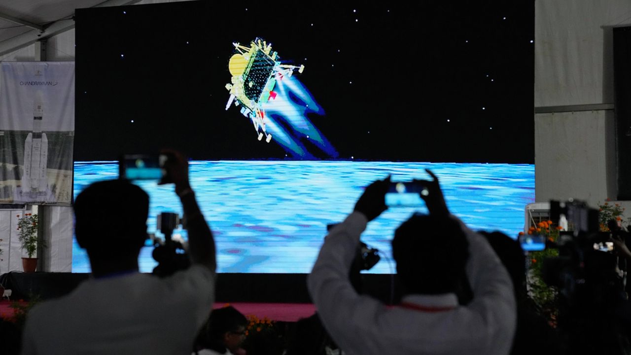 Journalists film the live telecast Wednesday of spacecraft Chandrayaan-3 landing on the moon at ISRO's Telemetry, Tracking and Command Network facility in Bengaluru, India.(AP Photo/Aijaz Rahi) 