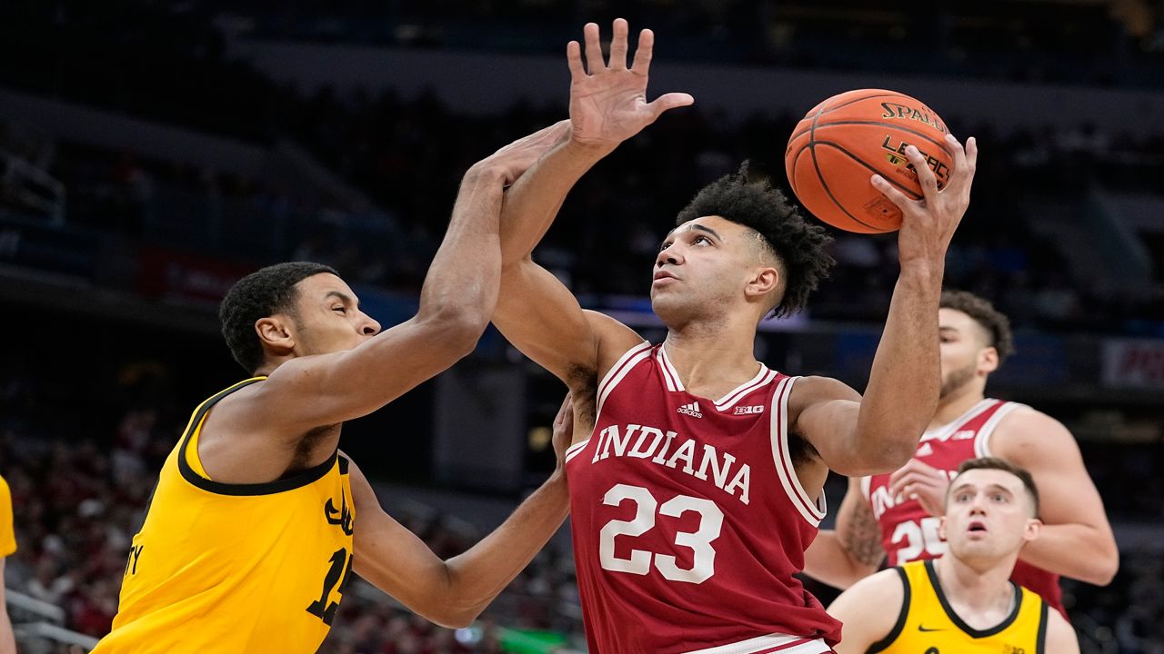 Indiana's Trayce Jackson-Davis (23) shoots against Iowa's Keegan Murray (15) during the first half of an NCAA college basketball game in the semifinal round at the Big Ten Conference tournament, Saturday, March 12, 2022, in Indianapolis. Indiana brings back star forward Trayce Jackson-Davis. (AP Photo/Darron Cummings)