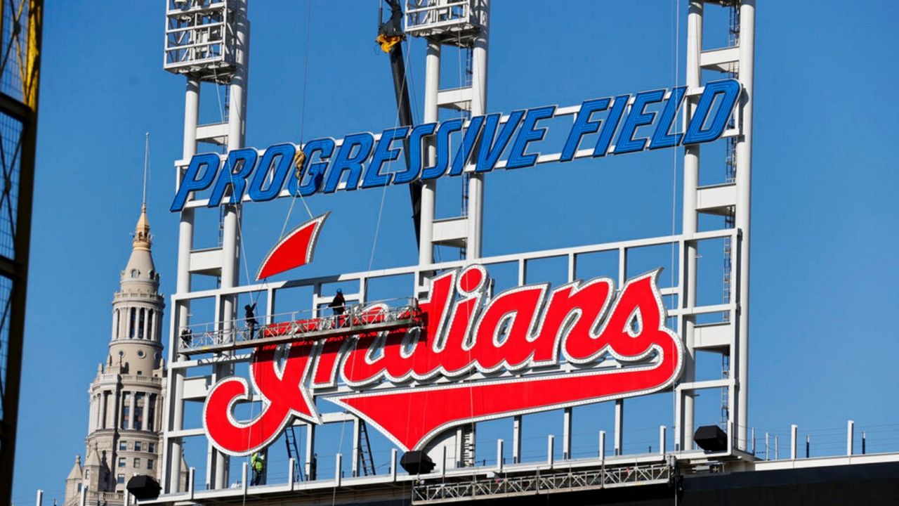 Workers begin to remove the Cleveland Indians sign from above the scoreboard at Progressive Field, Tuesday, Nov. 2, 2021, in Cleveland. Known as the Indians since 1915, Cleveland's Major League Baseball team will be called Guardians. (AP Photo/Ron Schwane)