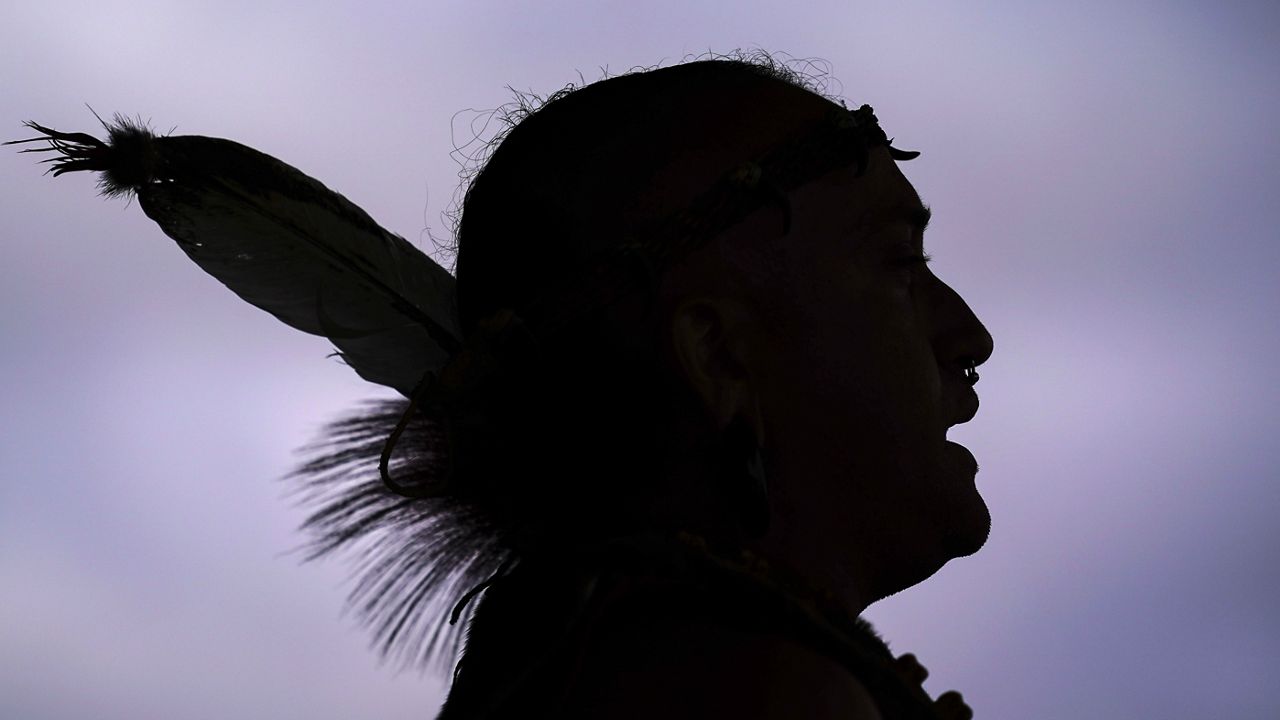 Tatanka Gibson of the Haliwa-Saponi/Nansemond Tribal Nations leads attendees in song and dance during a gathering marking Indigenous Peoples Day at Penn Treaty Park, Oct. 11, 2021, in Philadelphia. Native American people will celebrate their centuries-long history of resilience on Monday, Oct. 9, 2023, through ceremonies, dances and speeches. The events across the United States will come two years after President Joe Biden officially commemorated Indigenous Peoples Day. (AP Photo/Matt Rourke, File)