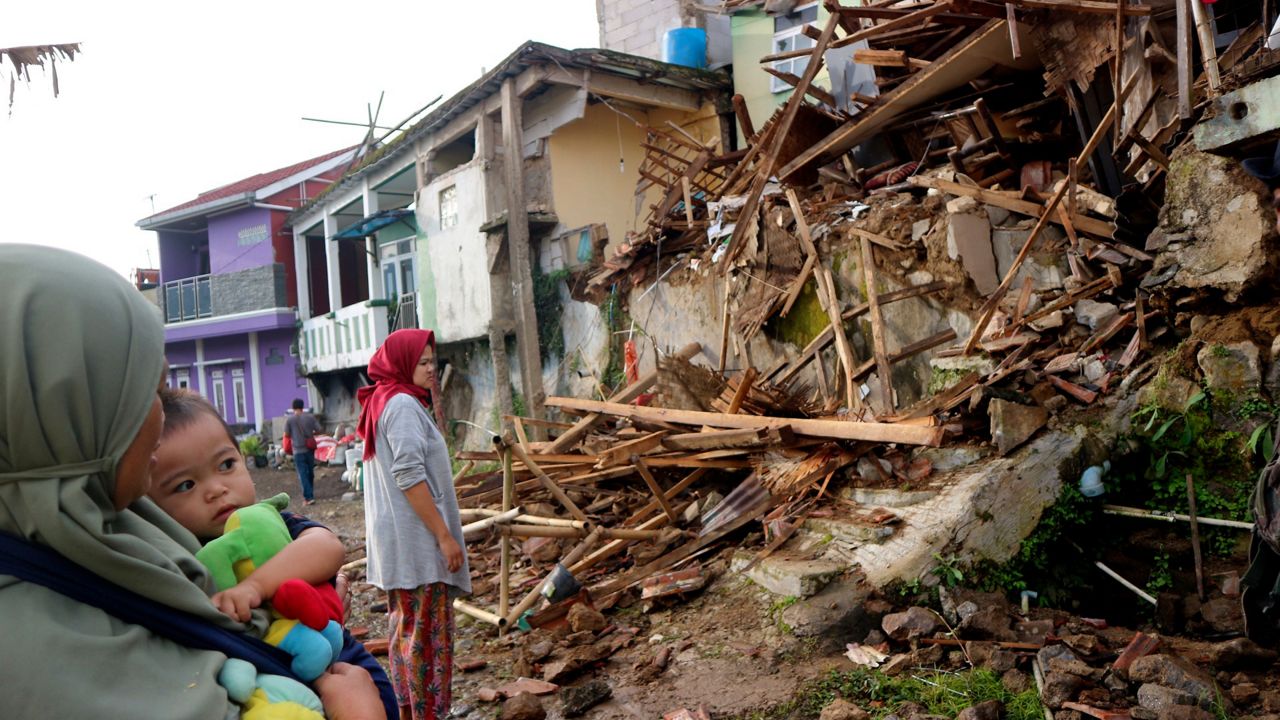 Residents on Tuesday inspect houses damaged by Monday's earthquake in Cianjur, West Java, Indonesia. (AP Photo/Rangga Firmansyah)