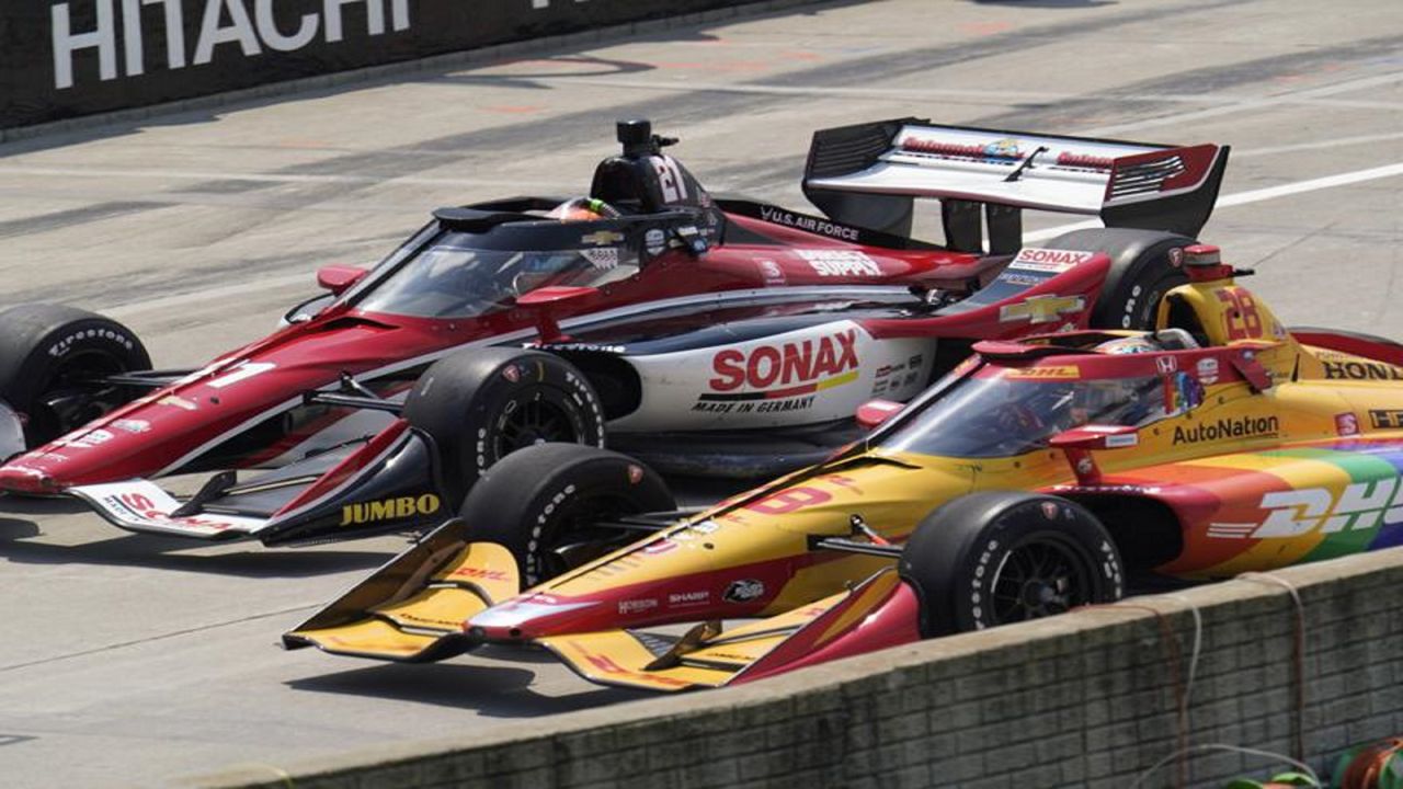 Rinus VeeKay (21) and Ryan Hunter-Reay (28) race off pit lane during the first race of the IndyCar Detroit Grand Prix auto racing doubleheader on Belle Isle in Detroit Saturday, June 12, 2021. (AP Photo/Paul Sancya)