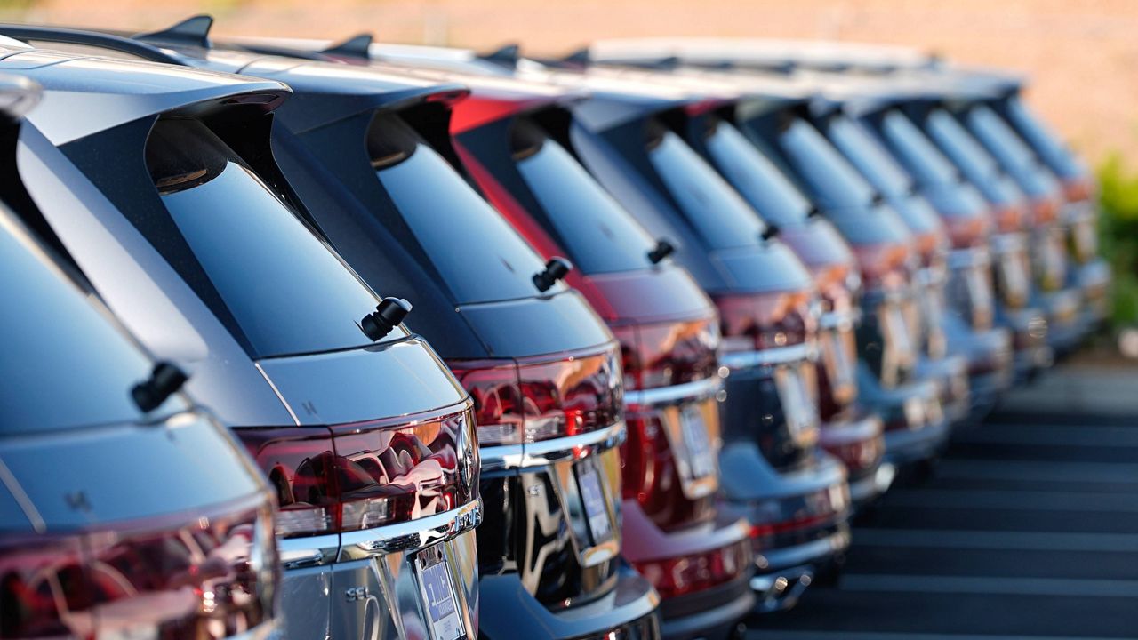 A long row of unsold 2024 Atlas utility vehicles is shown Sunday, July 28, 2024, at a Volkswagen dealership in Denver. (AP Photo/David Zalubowski)