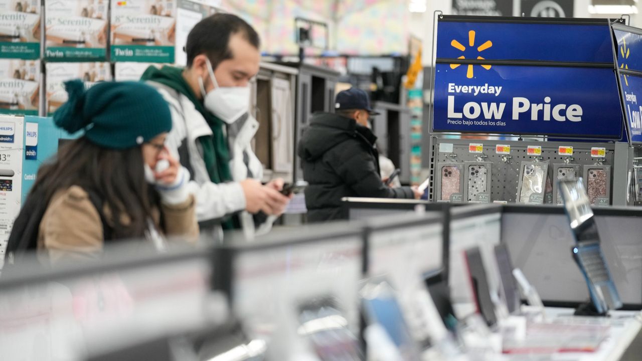 Signs advertise deals and low prices at a Walmart in Secaucus, N.J., on Nov. 22. (AP Photo/Seth Wenig, File)