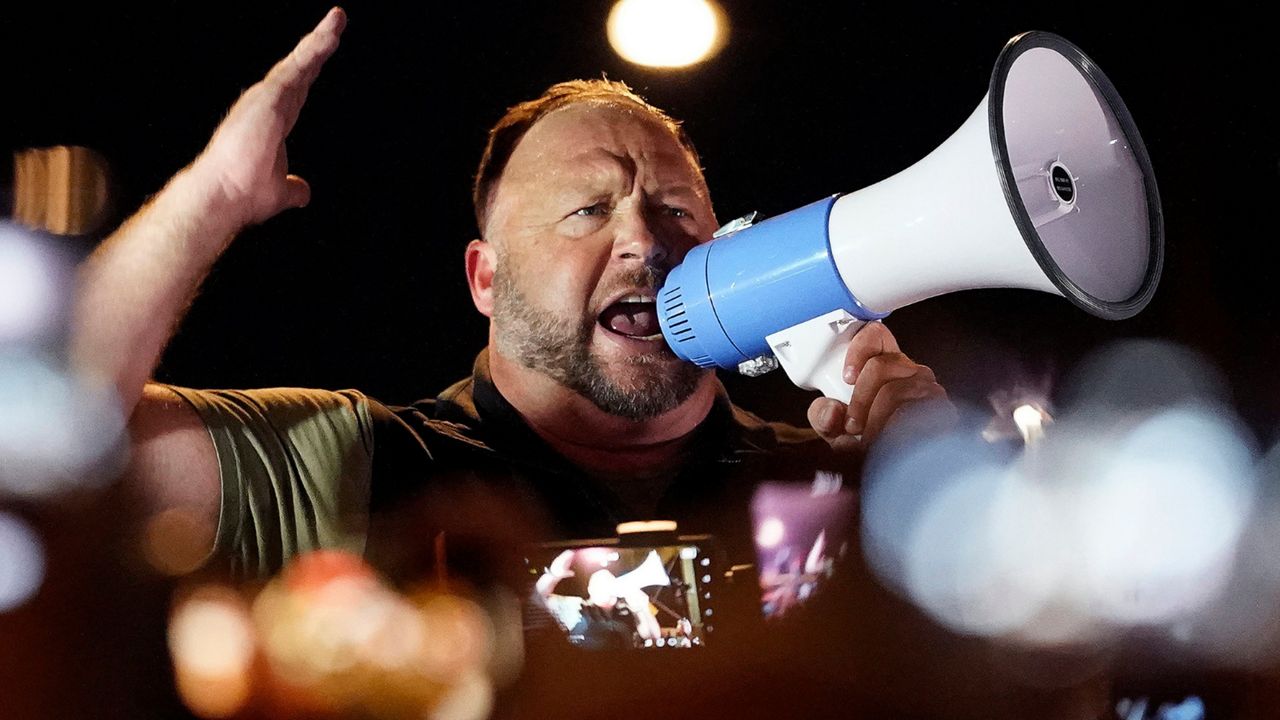 Infowars host and conspiracy theorist Alex Jones rallies pro-Trump supporters outside the Maricopa County Recorder's Office, on Nov. 5, 2020, in Phoenix, Ariz. A federal judge in Texas has dismissed the bankruptcy protection case of Infowars and two other companies controlled by Alex Jones. The ruling on Friday, June 10, 2022, was the result of an agreement between lawyers for the conspiracy theorist and parents of some of the children slain in the 2012 Sandy Hook Elementary School shooting. (AP Photo/Matt York, File)