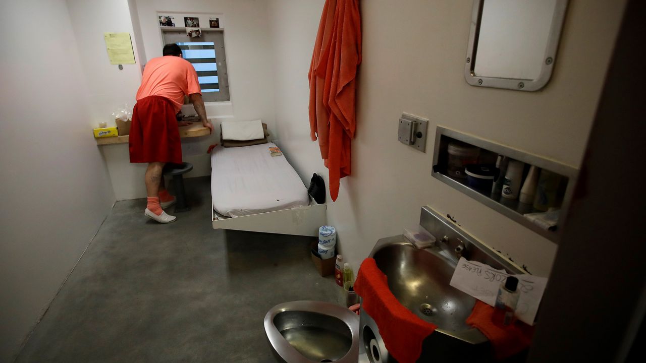 FILE - An inmate looks out a window in his solitary confinement cell at the Main Jail in San Jose, Calif., on Dec. 16, 2019. California Gov. Gavin Newsom delivered a mixed verdict on more than three dozen criminal justice laws before his bill-signing deadline on Friday, Sept. 30, 2022. (AP Photo/Ben Margot, File)