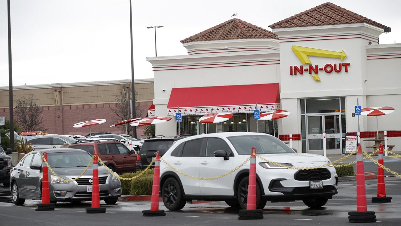 Customers line up at the In-N-Out drive-thru off Hegenberger Road in Oakland, Calif., on Monday, Jan. 22, 2024.  (Jane Tyska/Bay Area News Group via AP)