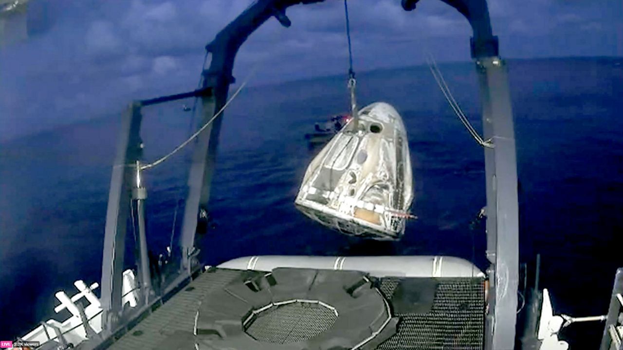 The SpaceX Inspiration4 capsule is lifted from the water after successfully splashing down Saturday off the coast of Florida. (SpaceX)
