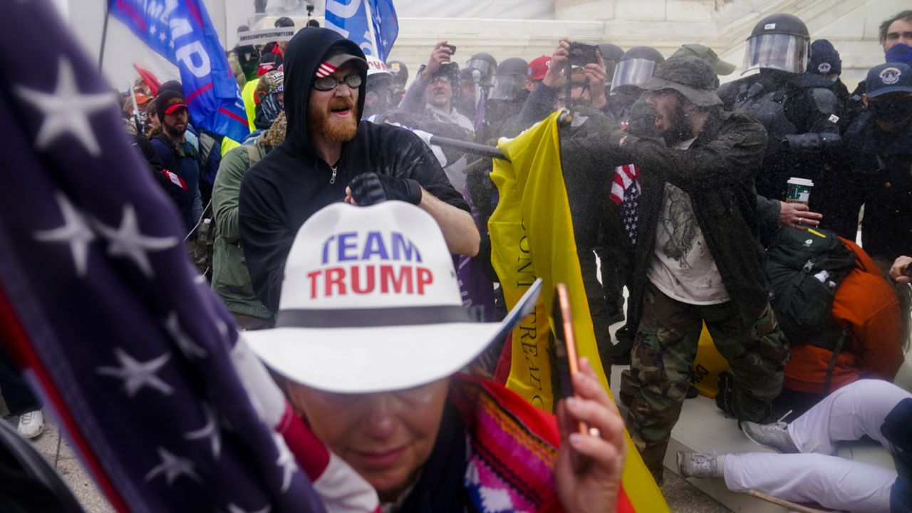 In this Jan. 6, 2021, file photo, insurrections loyal to President Donald Trump try to break through a police barrier at the Capitol in Washington. The Department of Justice is prosecuting those who violently stormed the Capitol. More than 870 people have been charged and more than 400 convicted. (AP Photo/John Minchillo, File)