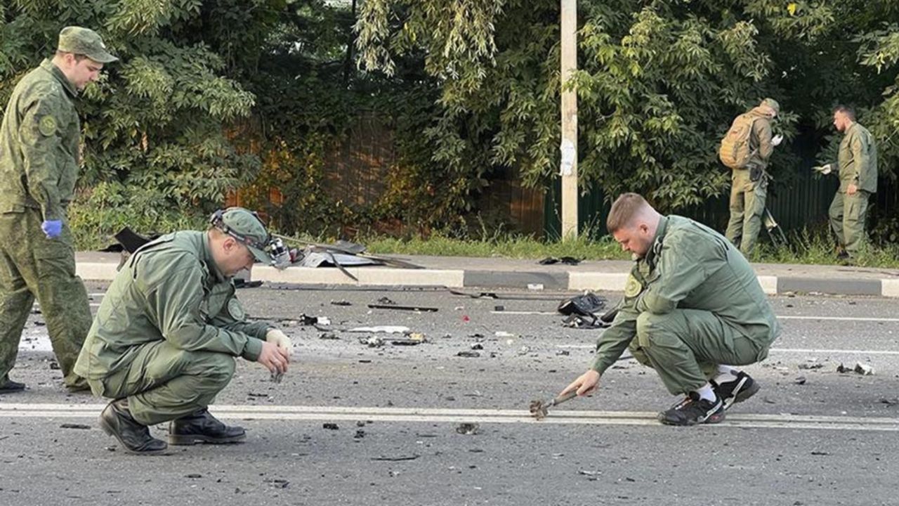 In this handout photo taken from video released by Investigative Committee of Russia on Sunday, Aug. 21, 2022, investigators work on the site of explosion of a car driven by Daria Dugina outside Moscow. Daria Dugina, the daughter of Alexander Dugin, the Russian nationalist ideologist often called "Putin's brain", was killed when her car exploded on the outskirts of Moscow, officials said Sunday. The Investigate Committee branch for the Moscow region said the Saturday night blast was caused by a bomb planted in the SUV driven by Daria Dugina.