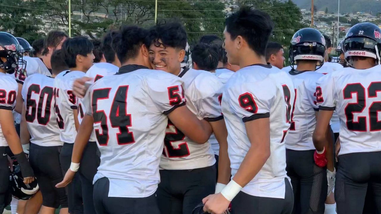 Iolani players embraced after defeating Lahainaluna 38-0 to win the HHSAA Division I championship.