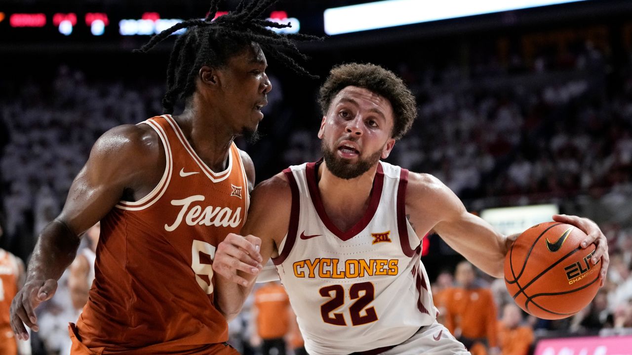 Iowa State guard Gabe Kalscheur (22) is fouled by Texas guard Marcus Carr (5) while driving to the basket during the second half of an NCAA college basketball game, Tuesday, Jan. 17, 2023, in Ames, Iowa. (AP Photo/Charlie Neibergall)