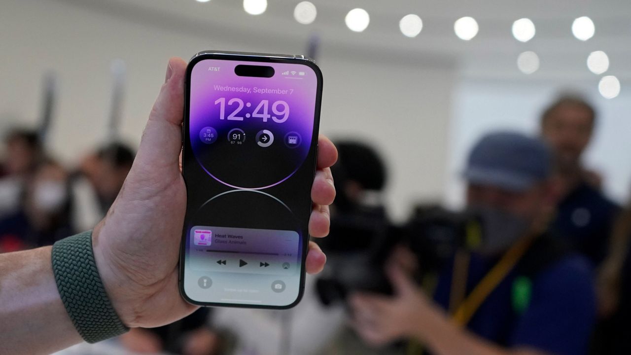 A person holds a new iPhone 14 Pro on Wednesday at an event on the campus of Apple's headquarters in Cupertino, Calif. (AP Photo/Jeff Chiu)