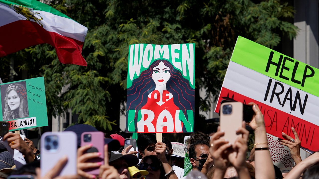 Iranian Americans participate in a rally in downtown Los Angeles on Saturday, Oct. 1, 2022, in solidarity with women in Iran, after 22-year-old woman Mahsa Amini died in police custody. She had been detained by the morality police in Iran's capital, Tehran, for allegedly wearing a mandatory headscarf too loosely. (AP Photo/Damian Dovarganes)