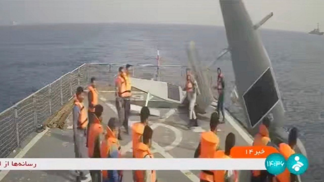 In this frame grab from Iranian state television, Iranian navy sailors throw an American sea drone overboard in the Red Sea on Thursday, Sept. 1, 2022. Iran said Friday its navy seized two American sea drones in the Red Sea before letting them go, the latest maritime incident involving the U.S. Navy's new drone fleet in the Mideast. Cmdr. Timothy Hawkins, a spokesman for the Navy's Mideast-based 5th Fleet, acknowledged the incident on Friday to The Associated Press but declined to immediately elaborate. (Iranian state television via AP)