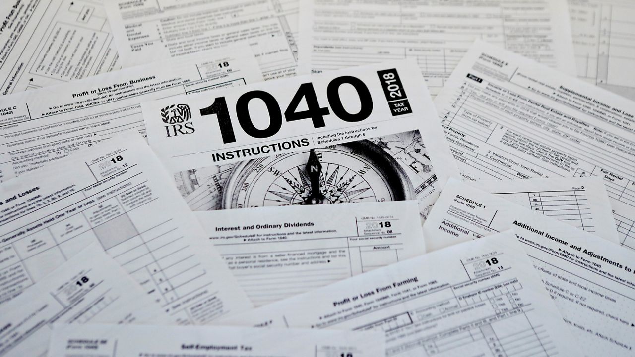 This photo shows multiple forms printed from the Internal Revenue Service web page in Zelienople, Pa., Feb. 13, 2019. (AP Photo/Keith Srakocic, File)