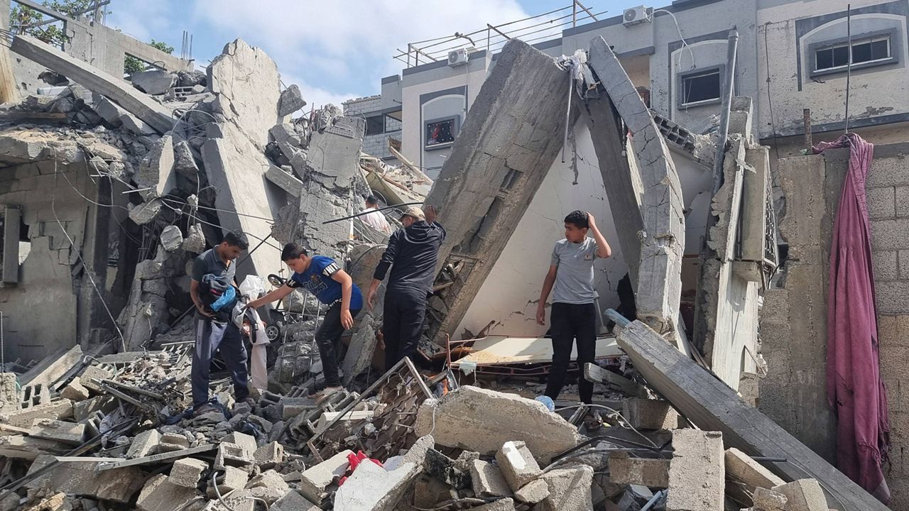 Palestinians look at the destruction after an airstrike in Rafah on Monday, April 29, 2024.