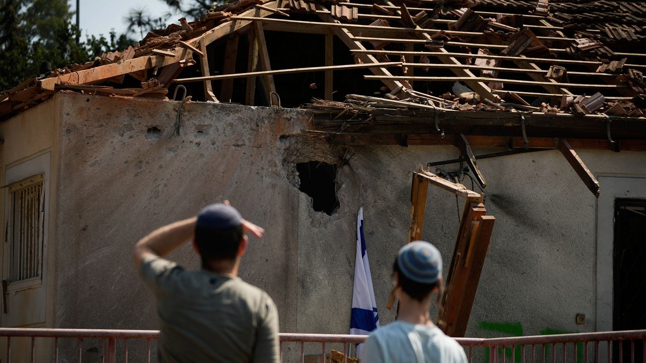 People look at a damaged house that was hit by a rocket fired from Lebanon, near Safed, northern Israel, on Wednesday, Sept. 25, 2024. (AP Photo//Leo Correa)