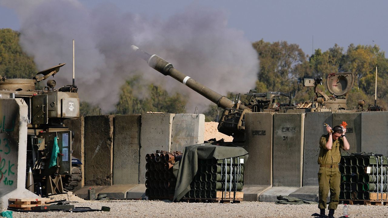 An Israeli soldier covers his ears as an artillery gunner fires into the Gaza Strip from a position in southern Israel, Thursday, Jan. 2, 2025. (AP Photo/Matias Delacroix)