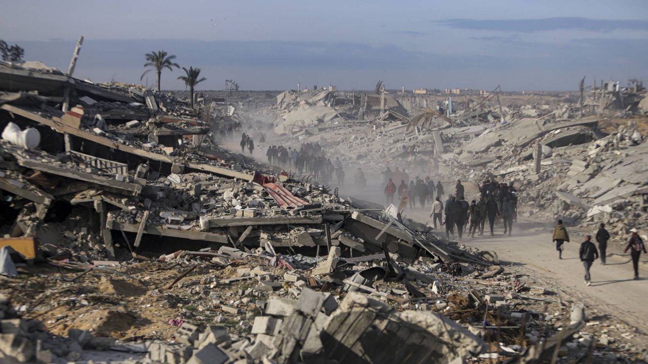 Displaced Palestinians leave parts of Khan Younis as they go back to their homes in Rafah, southern Gaza Strip, Sunday, Jan. 19, 2025. (AP Photo/Jehad Alshrafi)