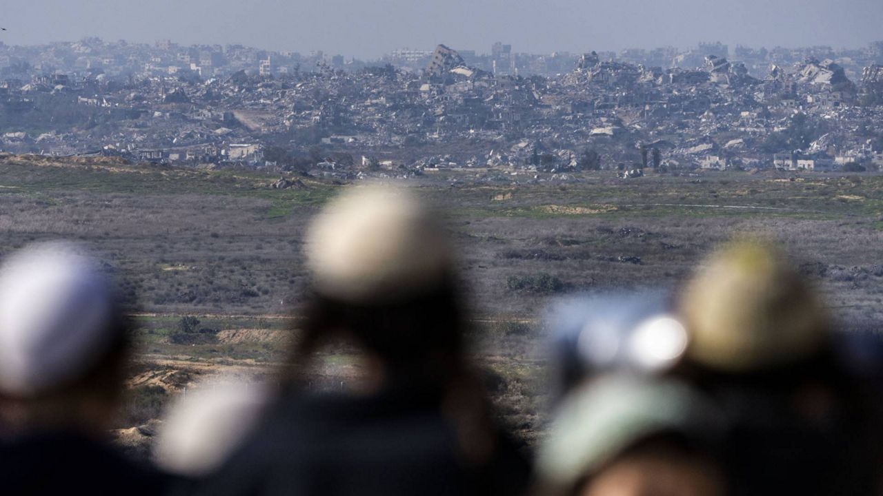 People watch the Gaza Strip from an observation point in Sderot, southern Israel, Monday, Jan. 13, 2025. (AP Photo/Ariel Schalit)