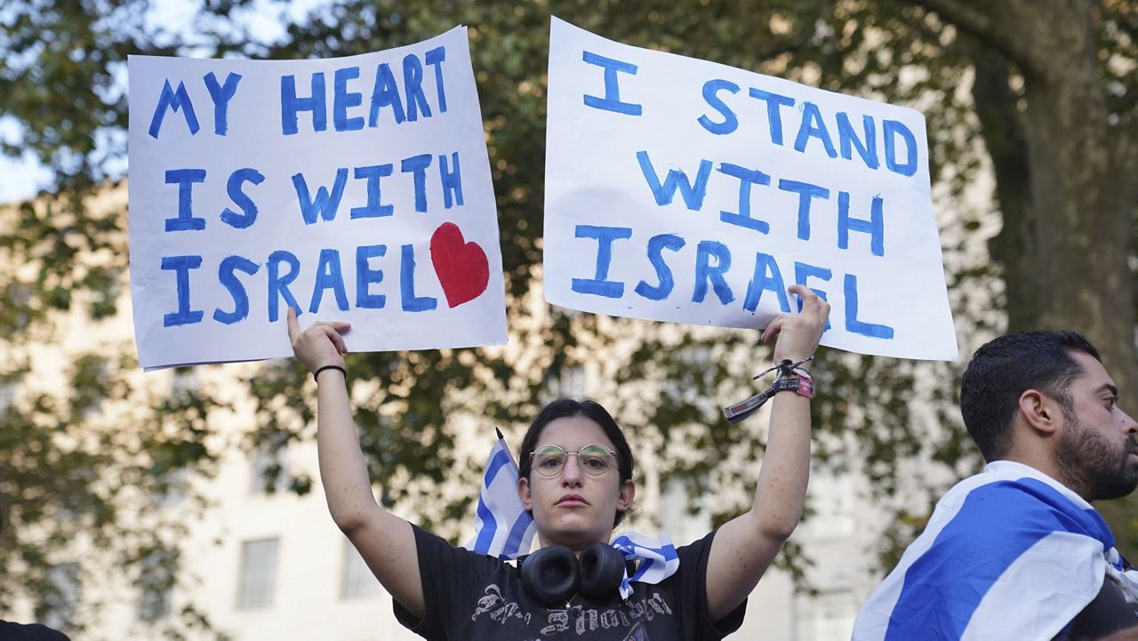 People attend a vigil outside Downing Street for victims and hostages of Hamas attacks in London, Monday, Oct. 9, 2023. (Lucy North/PA via AP)
