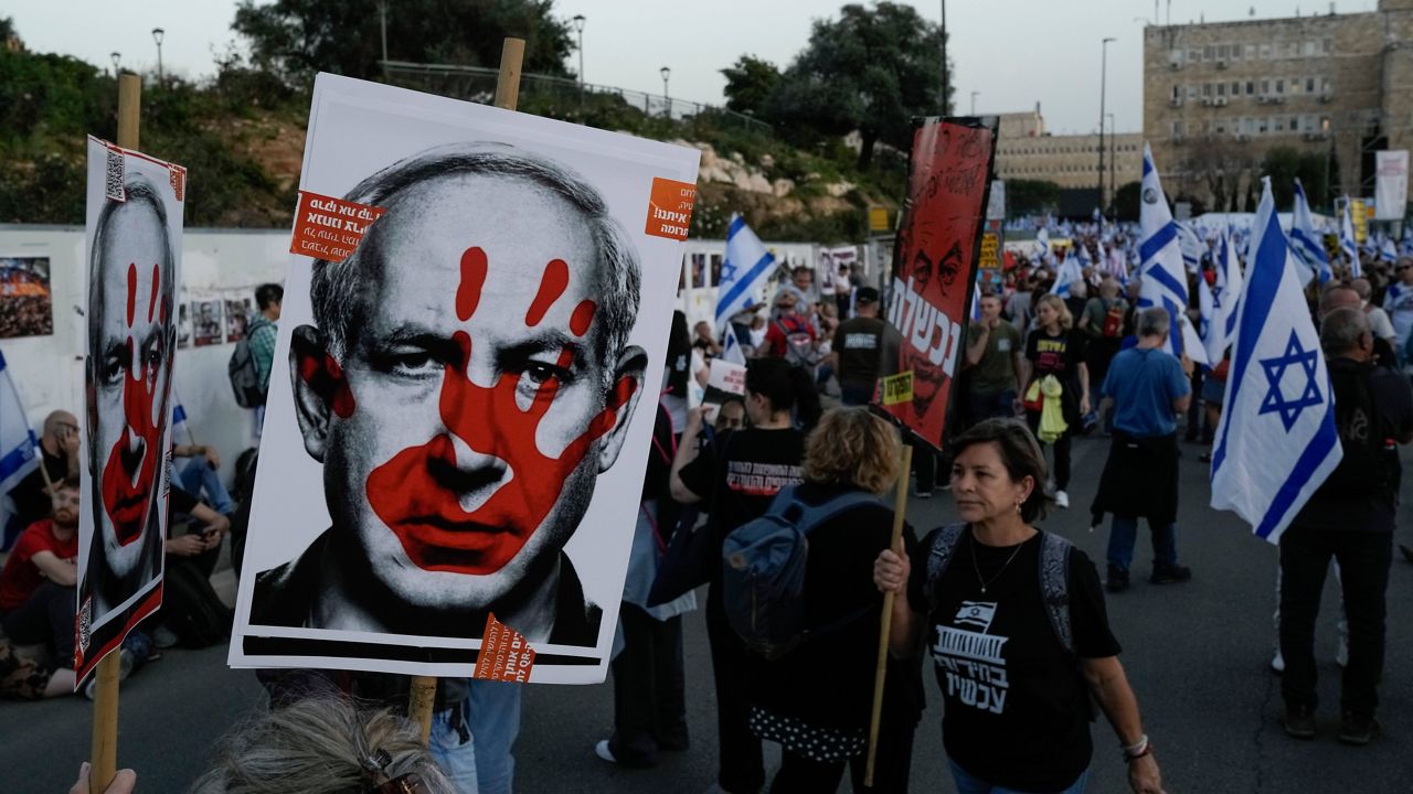 People take part in a protest against Israeli Prime Minister Benjamin Netanyahu's government and call for the release of hostages held in the Gaza Strip by the Hamas militant group outside of the Knesset, Israel's parliament, in Jerusalem, Sunday, March 31, 2024. (AP Photo/Leo Correa)