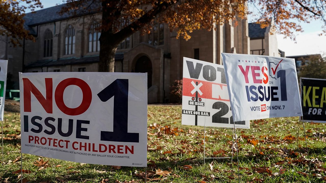 Issue 1 signs sit outside Knox Presbyterian Church on Election Day, Tuesday, Nov. 7, 2023, in Cincinnati. (AP Photo/Joshua A. Bickel)