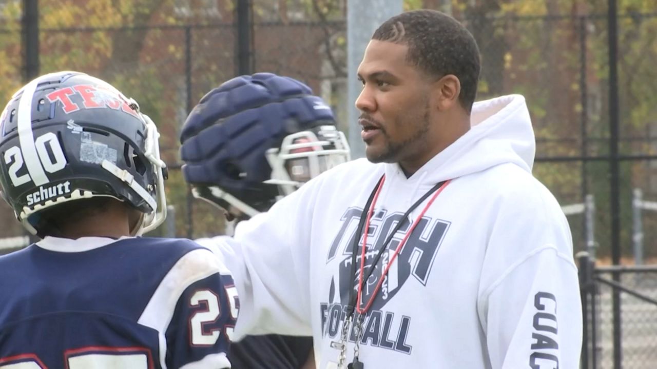 itc football coach, at right, talks to players at a practice