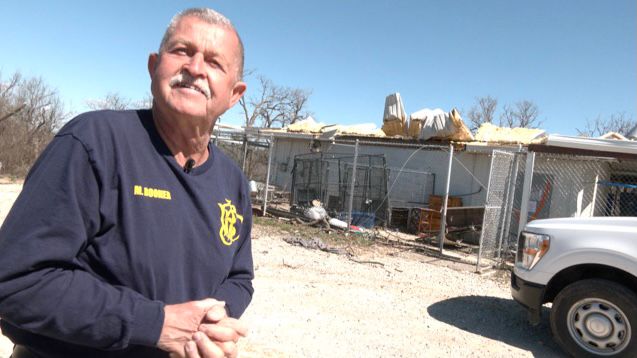 Jacksboro Animal Control Officer Michael Booher shows the damage at the city's small animal shelter, where he and more than a dozen dogs survived an EF-3 tornado on March 21, 2022. (Spectrum News 1/Brian Scott)
