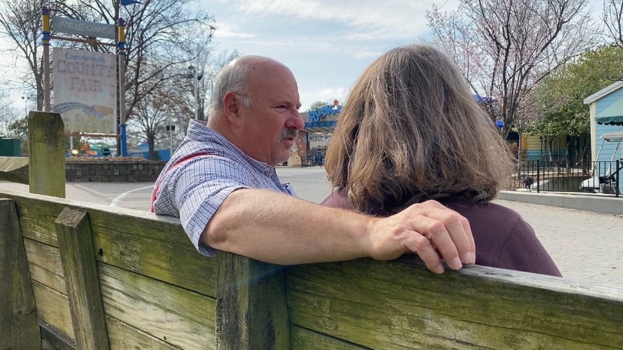 Steve and Dean Jackson on a bench at Carowinds
