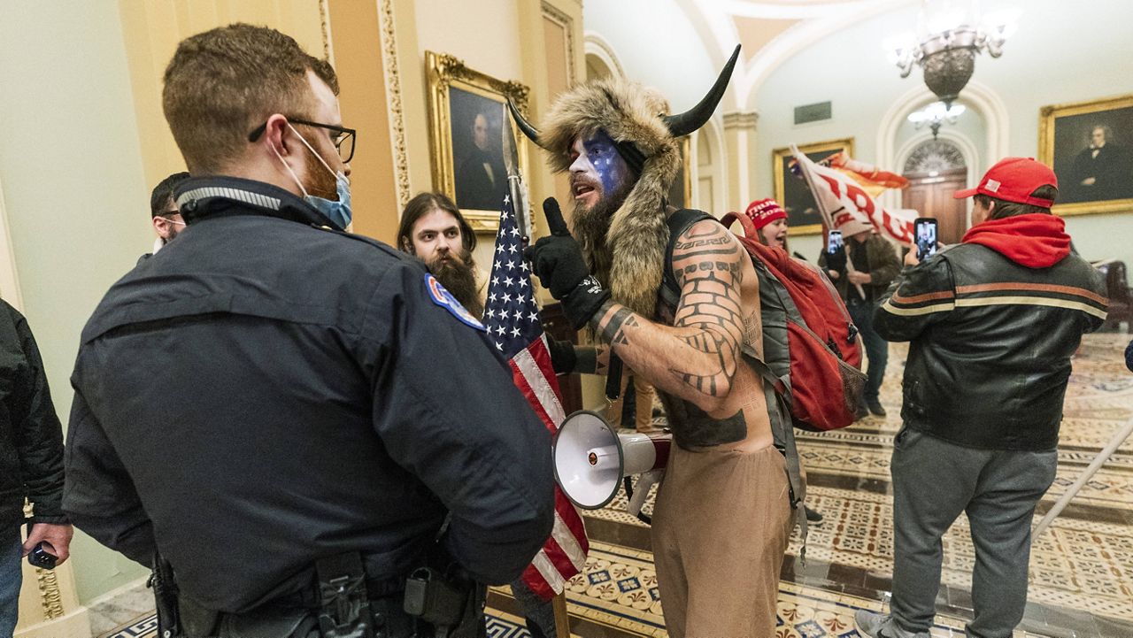 Jacob Chansley confronts a U.S. Capitol Police officer on Jan. 6. (AP Photo/Manuel Balce Ceneta, File)