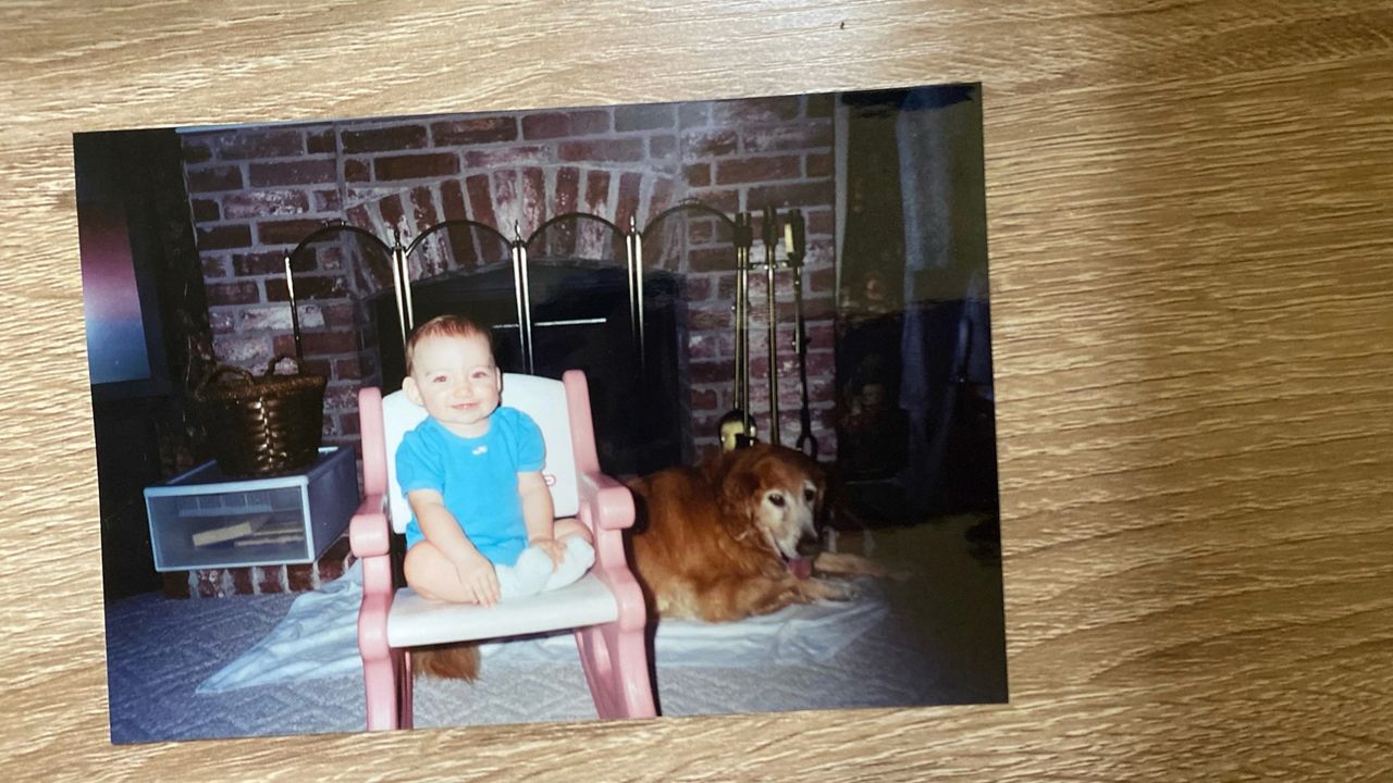 Pictured is a 1-year-old Jacqueline Durand with her father’s golden retriever. She feels their bond sparked her lifelong love for dogs.