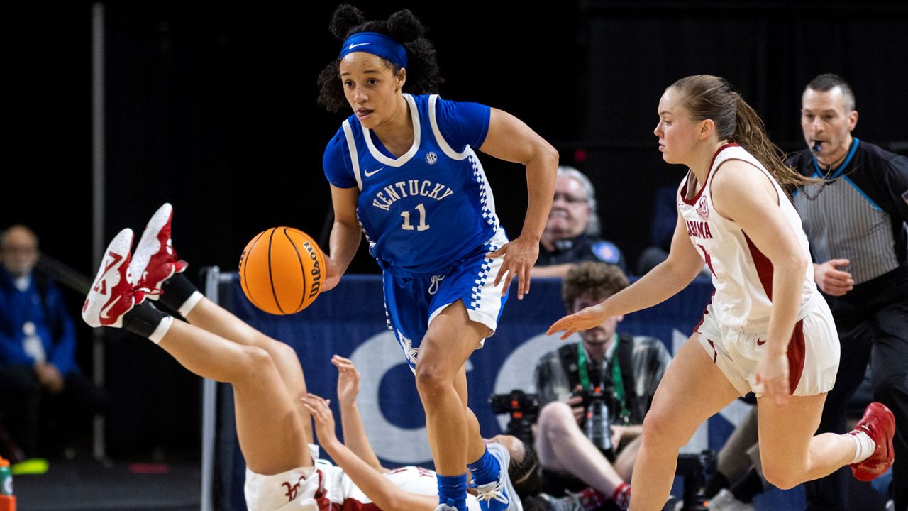 Kentucky's Jada Walker (11) dribbles the ball past Alabama's Hannah Barber (5) during the second half of an NCAA college basketball game at the Southeastern Conference women's tournament in Greenville, S.C., Thursday, March 2, 2023. (AP Photo/Mic Smith)