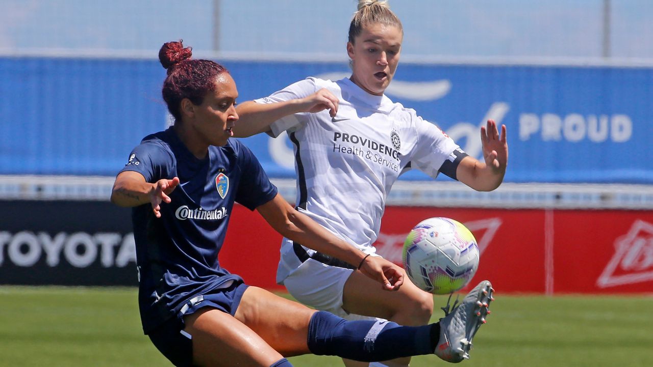 North Carolina Courage defender Jaelene Daniels, left, and Portland Thorns FC defender Christen Westphal, right, battle for the ball during the second half of an NWSL Challenge Cup soccer match at Zions Bank Stadium Saturday, June 27, 2020, in Herriman, Utah. (AP Photo/Rick Bowmer)