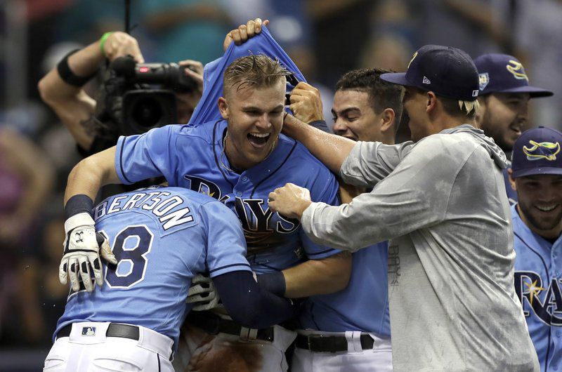 Tampa Bay Rays’ Jake Bauers, center, celebrates with teammates after his walkoff home run off New York Yankees relief pitcher Chasen Shreve during the 12th inning of a baseball game Sunday, June 24, 2018, in St. Petersburg, Fla. (AP Photo/Chris O’Meara)