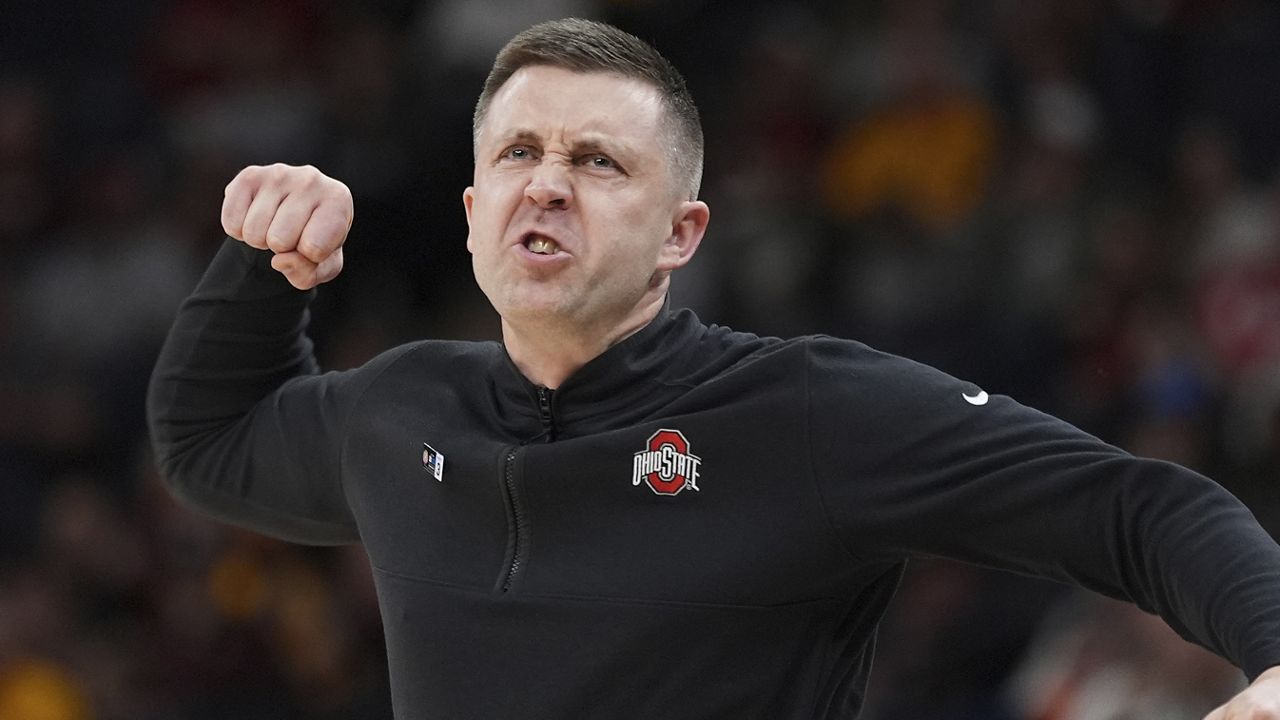 Ohio State interim head coach Jake Diebler celebrates play during the second half of an NCAA college basketball game against Iowa in the second round of the Big Ten Conference tournament, Thursday, March 14, 2024, in Minneapolis. (AP Photo/Abbie Parr)