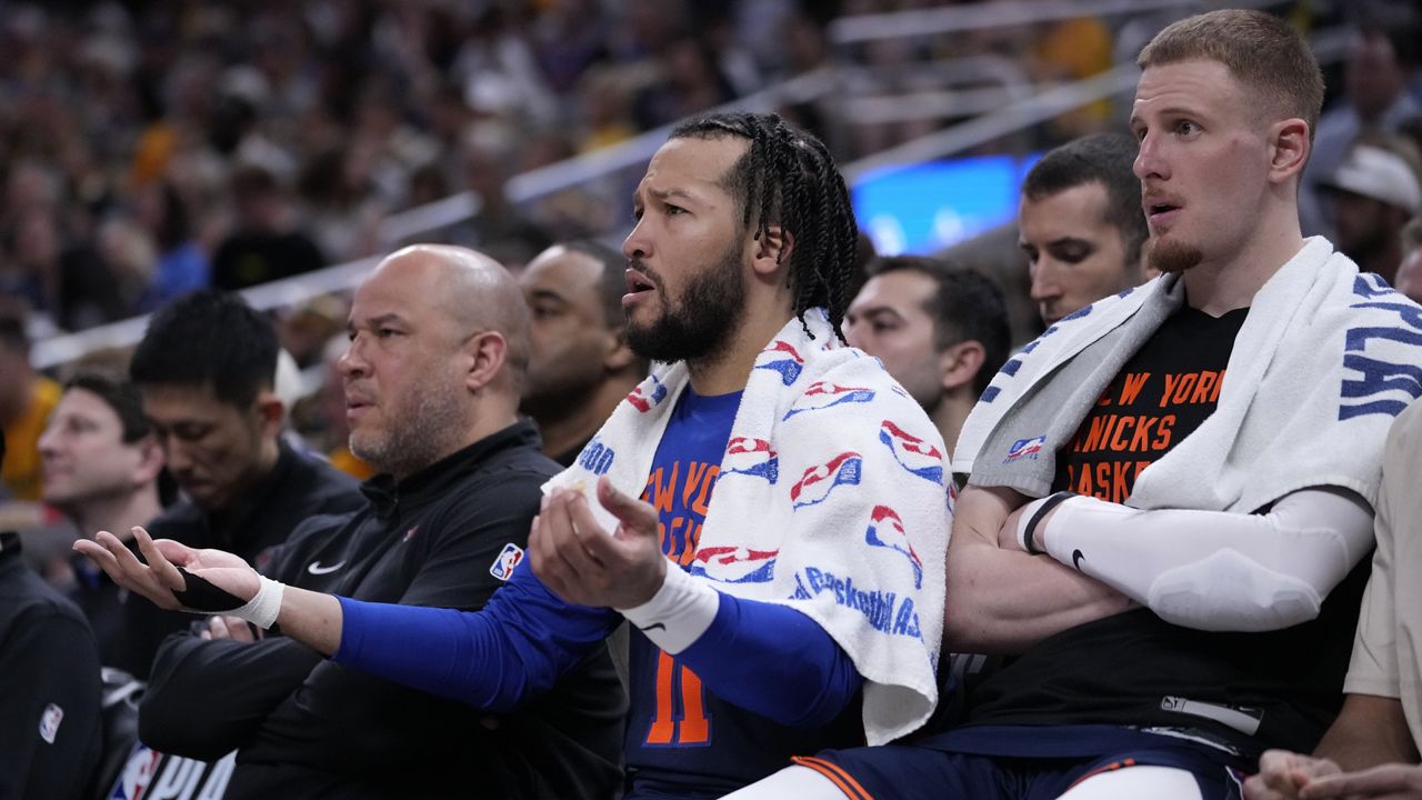 New York Knicks guard Jalen Brunson and guard Donte DiVincenzo, right, watch from the bench during the second half of Game 4.