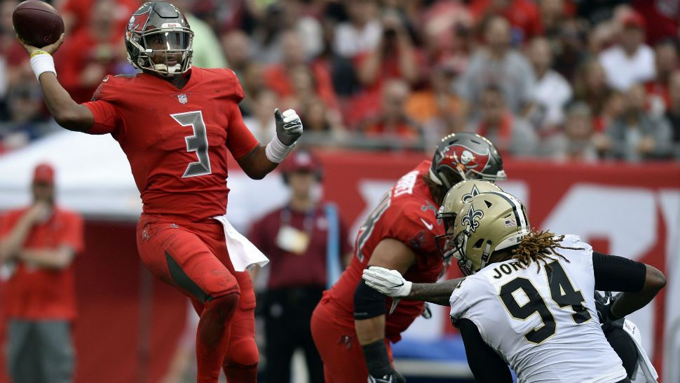 Tampa Bay Buccaneers quarterback Jameis Winston (3) leaps to throw a pass over New Orleans Saints defensive end Cameron Jordan (94) during the first half of an NFL football game Sunday, Dec. 9, 2018, in Tampa, Fla. (AP Photo/Jason Behnken)