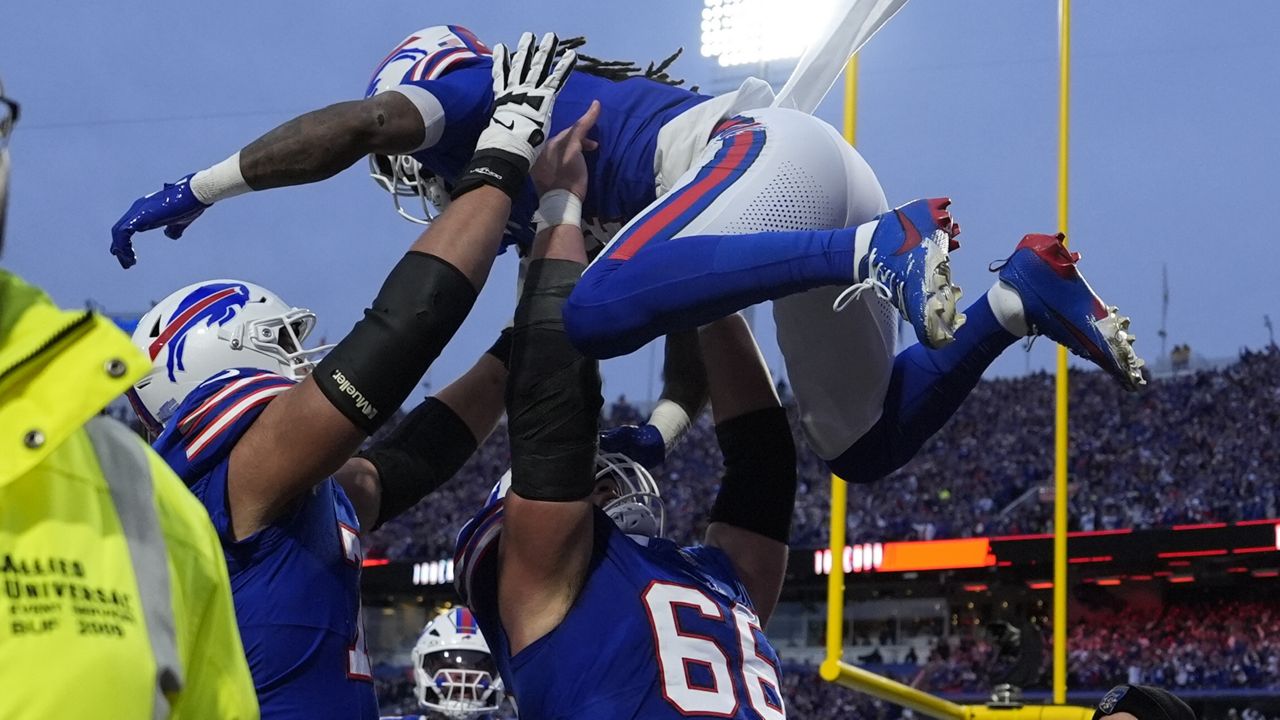 Buffalo Bills running back James Cook is lifted by teammate Connor McGovern (66) after scoring during the first half of an NFL football game against the Kansas City Chiefs Sunday, Nov. 17, 2024, in Orchard Park, N.Y. (AP Photo/Julia Demaree Nikhinson)