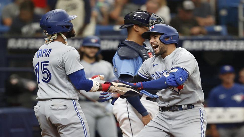 Toronto Blue Jays' George Springer, right, celebrates with teammate Ric Tapia after hitting a two-run home run against the Tampa Bay Rays during the third inning Sunday, Sept. 25, 2022, in St. Petersburg, Fla. (AP Photo/Scott Audette)