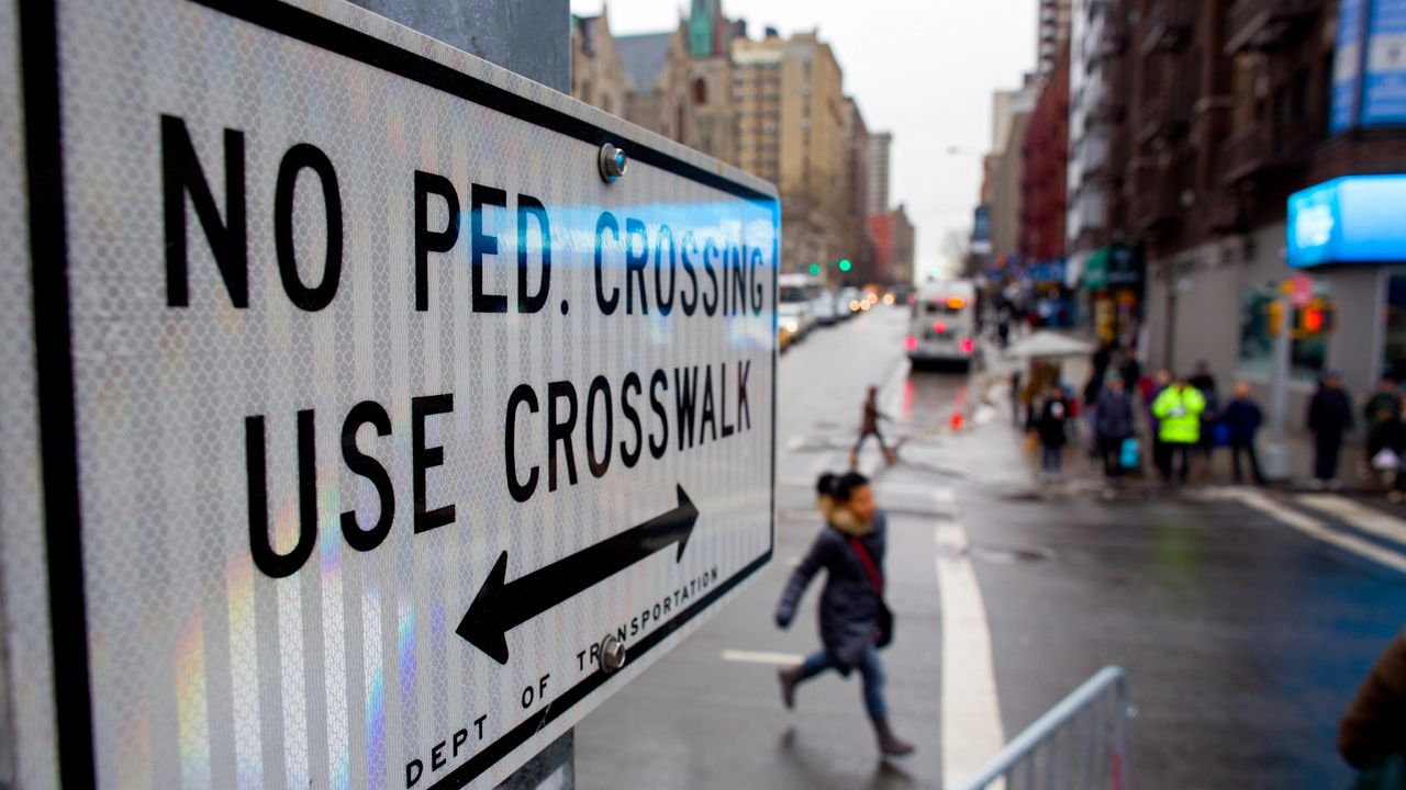 After crossing outside a crosswalk, a pedestrian, center, runs towards a crosswalk at the busy intersection of W. 96th Street and Broadway in the Upper West Side of New York Monday, Jan. 27, 2014. (AP Photo/Craig Ruttle, File)