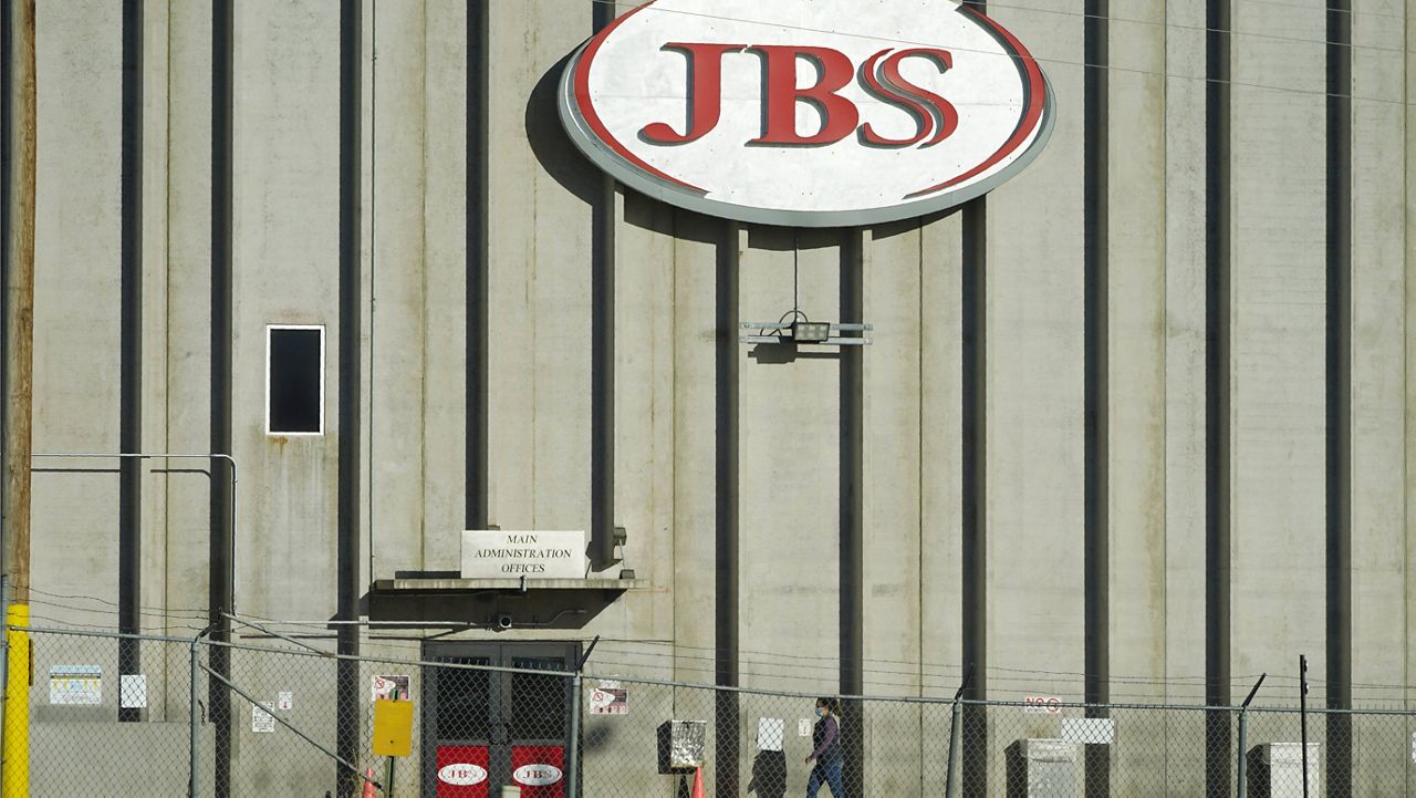 In this Oct. 12, 2020 file photo, a worker heads into the JBS meatpacking plant in Greeley, Colo. (AP Photo/David Zalubowski)