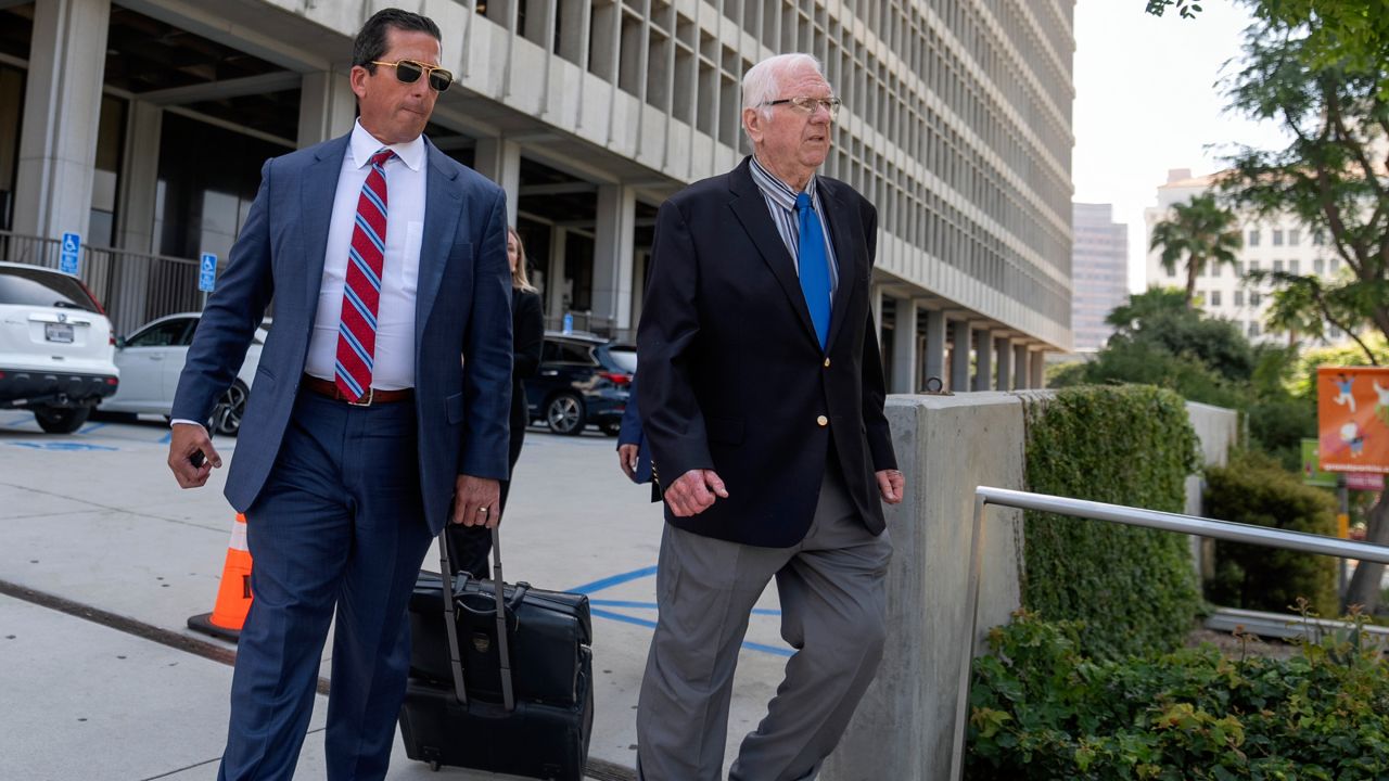 Orange County Superior Court Judge Jeffrey Ferguson, right, walks out of court with his attorney T. Edward Welbourn, after attending a preliminary hearing in Los Angeles on June 20, 2024. (AP Photo/Damian Dovarganes)