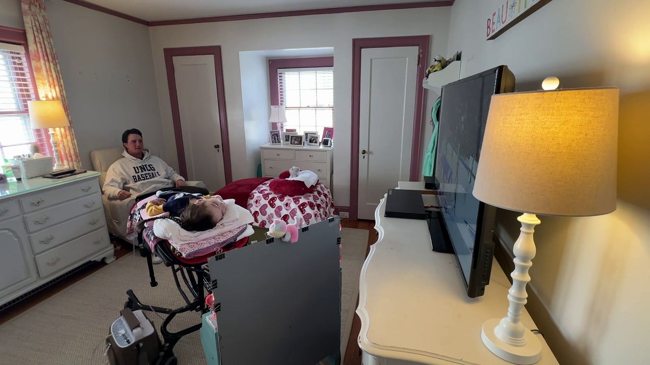 UNCG baseball player Luke Jenkins watches TV with his older sister Annabelle. (Spectrum News 1)