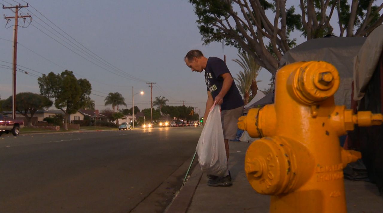 Jerry King walks at least three miles every night picking up trash around a homeless encampment. (Spectrum News)