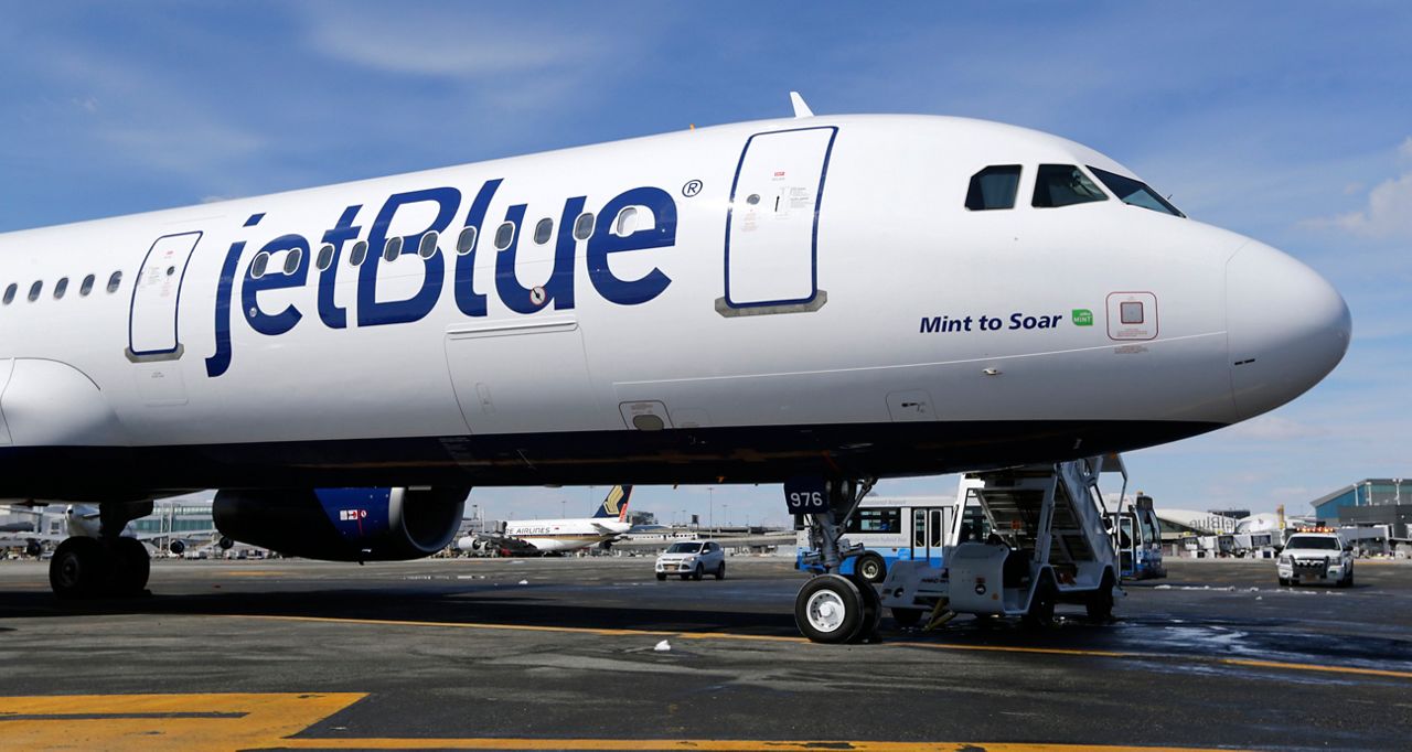 In this March 16, 2017, file photo, a Jet Blue airplane at John F. Kennedy International Airport in New York. (AP Photo/Seth Wenig)